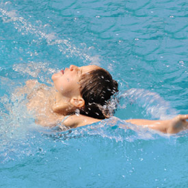 child backstroking in water